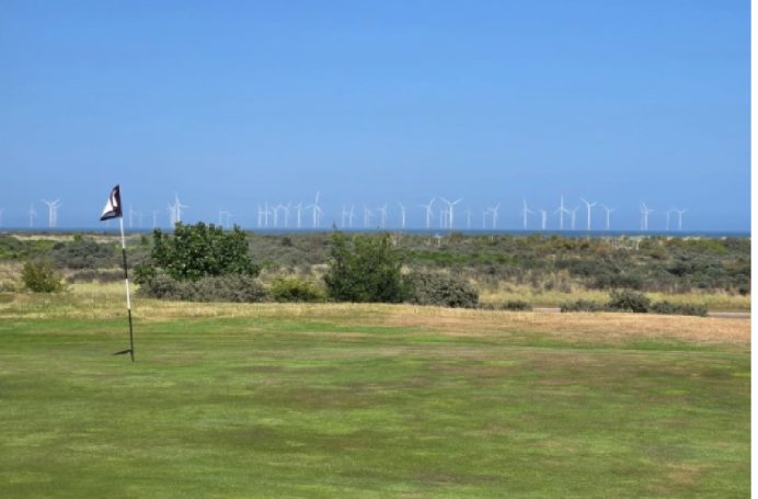 Green and wind farm in the distance